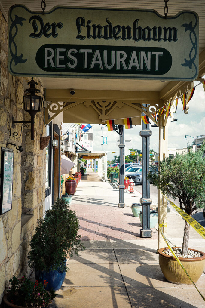 A quiet street scene in Fredericksburg, Texas, blending historic character with contemporary small-town life.