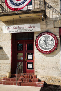 A quiet street scene in Fredericksburg, Texas, blending historic character with contemporary small-town life.