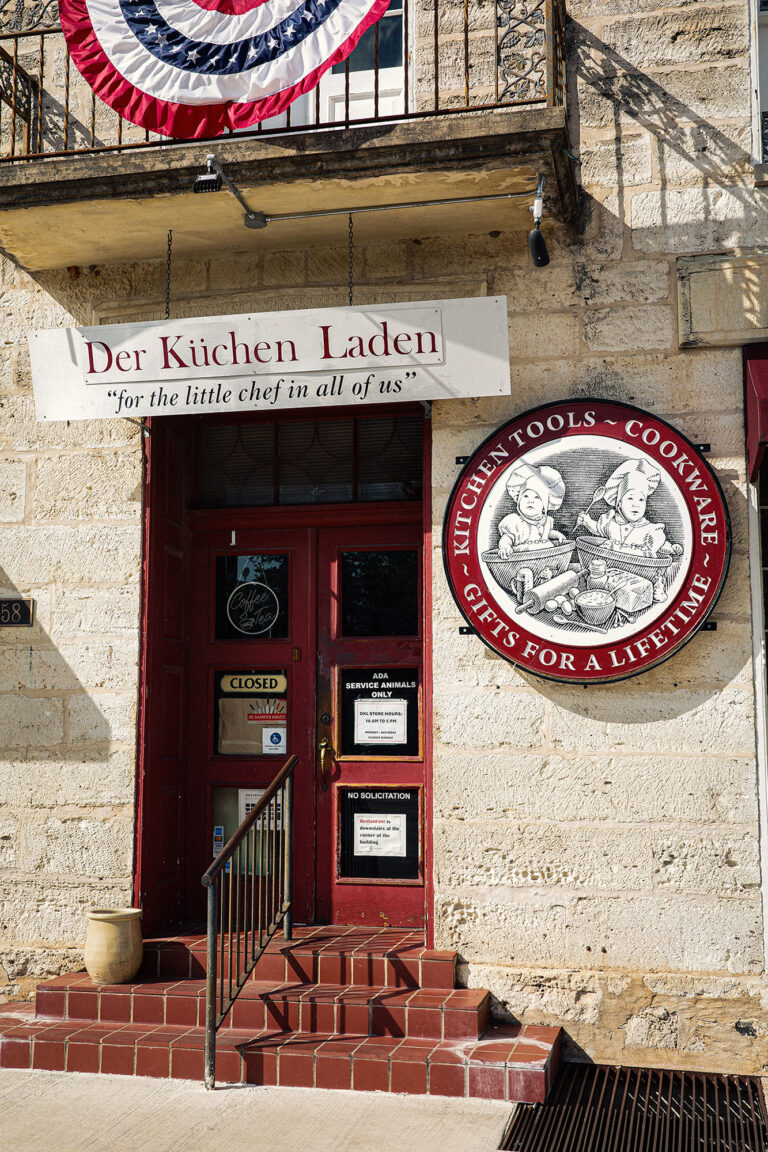 A quiet street scene in Fredericksburg, Texas, blending historic character with contemporary small-town life.